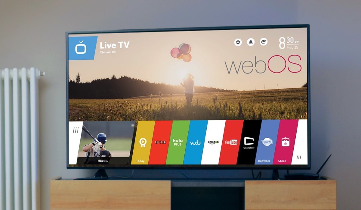 An LG Tv next to a radiator. The TV screen shows a background image and the WebOS menu interface