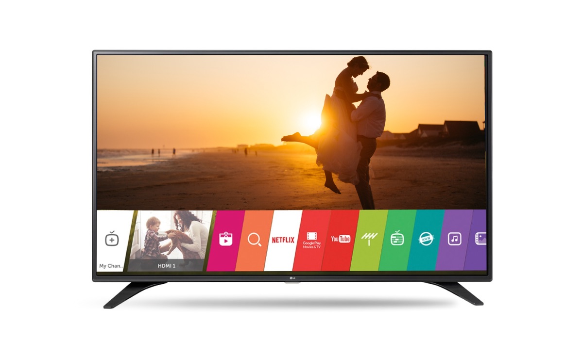 An LG TV with a background image of people in an embrace during a sunset. There's a WebOS interface on the bottom of the screen