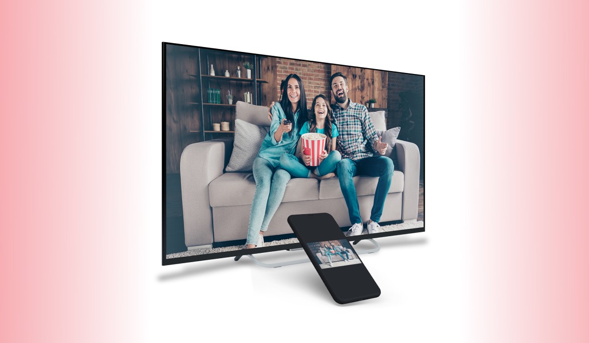 An LG TV and a smartphone showing and image of a Mom, dad and daughter sitting on a couch with a cinema-style container of popccorn