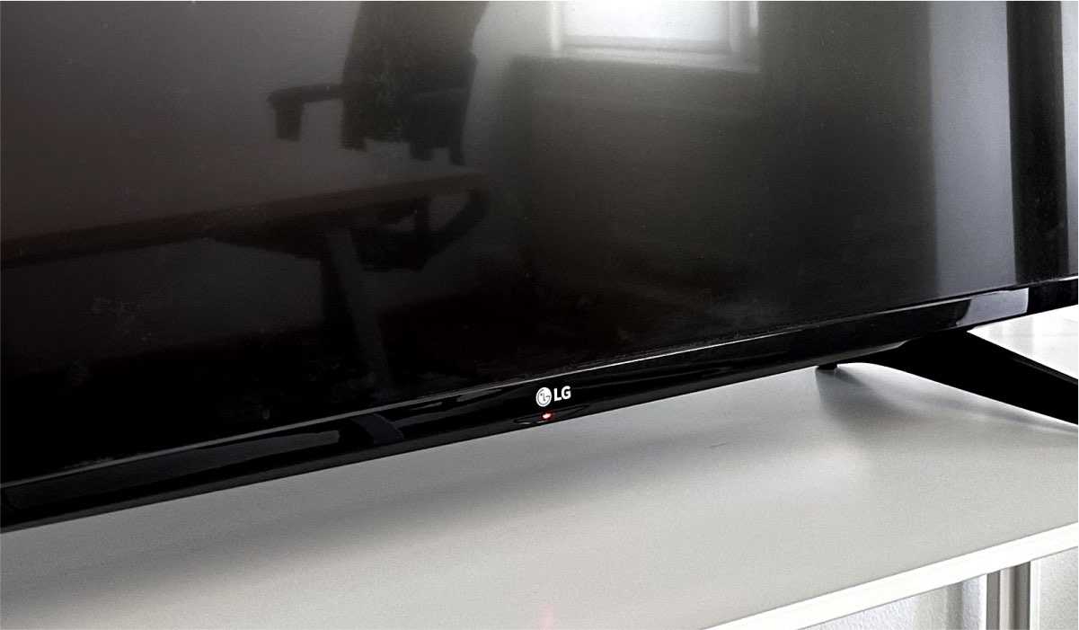 An LG TV on a TV stand. The TV screen is black